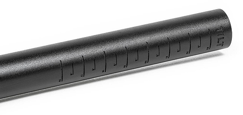 Close-up of a black, cylindrical shotgun microphone crafted from cold-formed aluminum, showcasing ridged sides and the brand name "Tilt" engraved near one end.