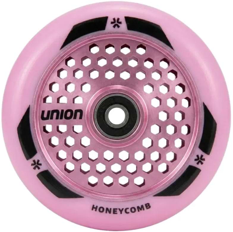 The Union Honeycomb Pro 110mm Stunt Scooter Wheel in pink features a honeycomb-patterned hollowcore metal design with black accents and "UNION" and "HONEYCOMB" printed on it.