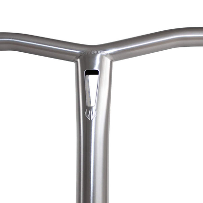 Close-up of the Entity Vulcan Titanium Oversized SCS Stunt Scooter Bars in silver, featuring a Grade 9 titanium handlebar with a distinctive triangular cutout and an emblem beneath it. The bar highlights its premium quality with a smooth, shiny finish.