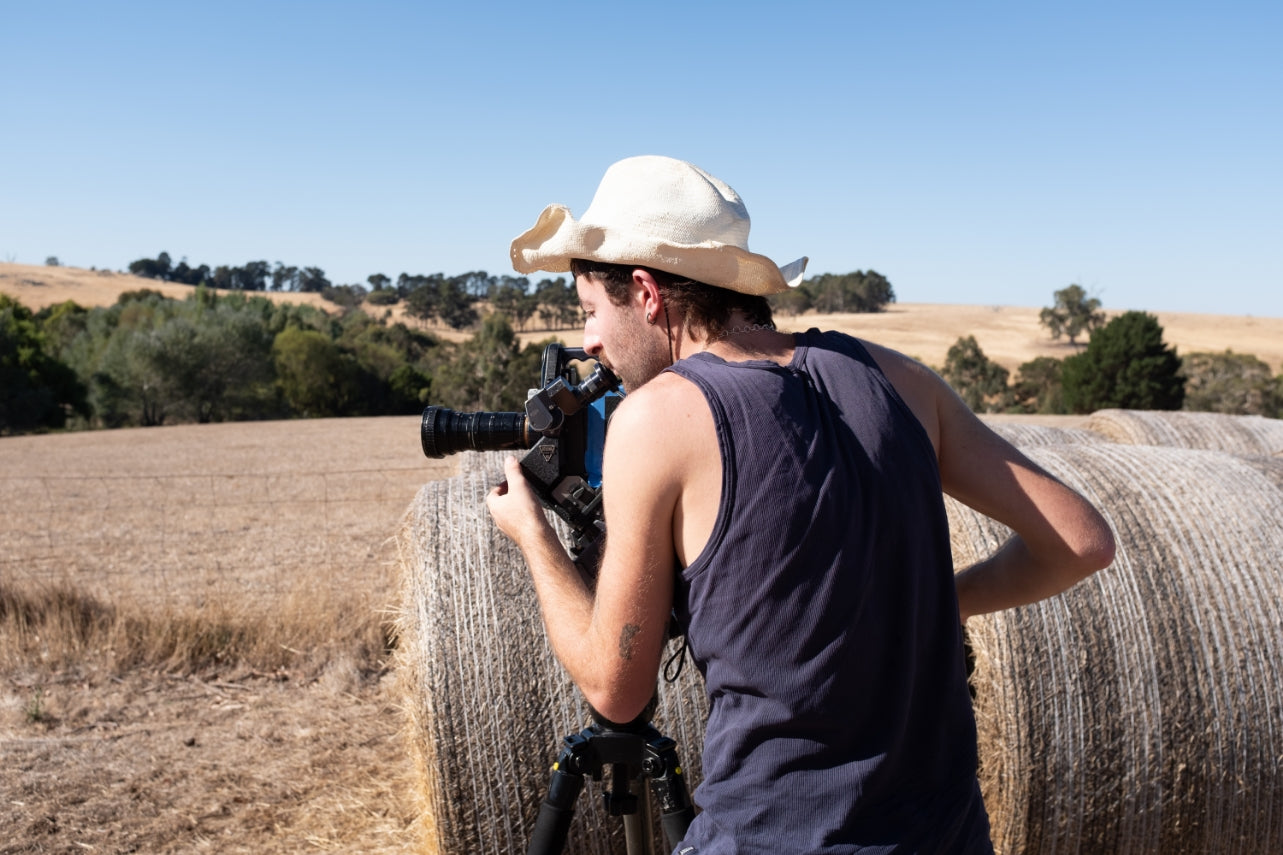 Image of videographer using an Eclair 16mm camera in outback Australia