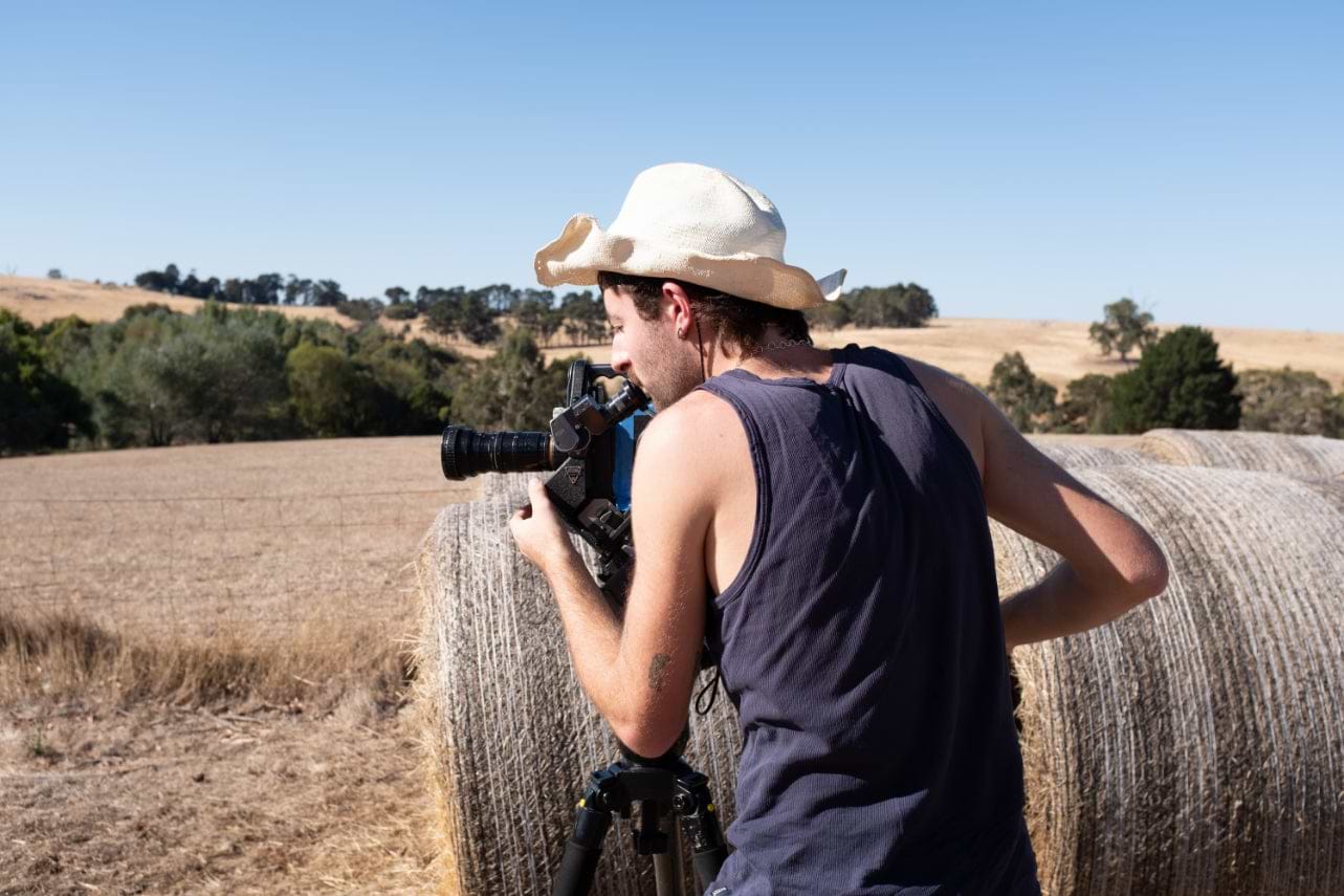 Image of videographer using an Eclair 16mm camera in outback Australia