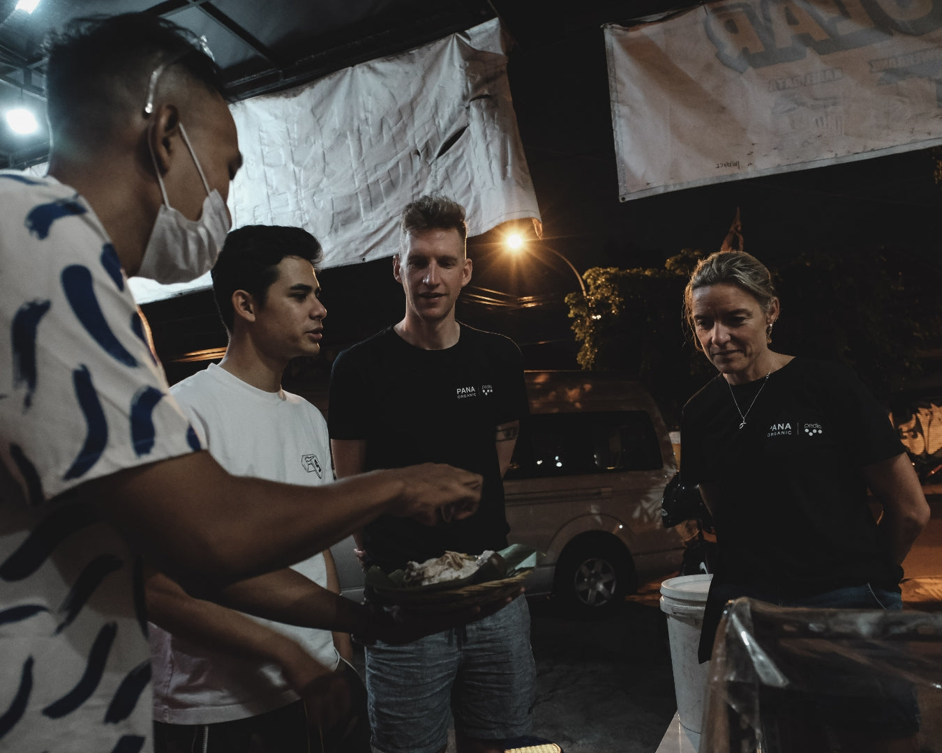 People chatting at night, discussing food