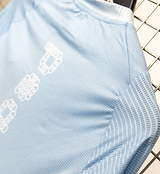 Men's Air long-sleeve cycling jersey back view — blue gradient with dots, breathable mesh panels on chest/back/sleeves, ventilated textured back pocket, lightweight moisture-wicking fabric, UPF 15+ sun protection, close unrestrictive fit.
