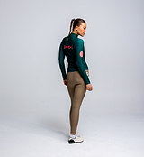 Rear view of Pedla’s Women’s Thermal LS Cycling Jersey in Pine with three-pocket design and reflective logos