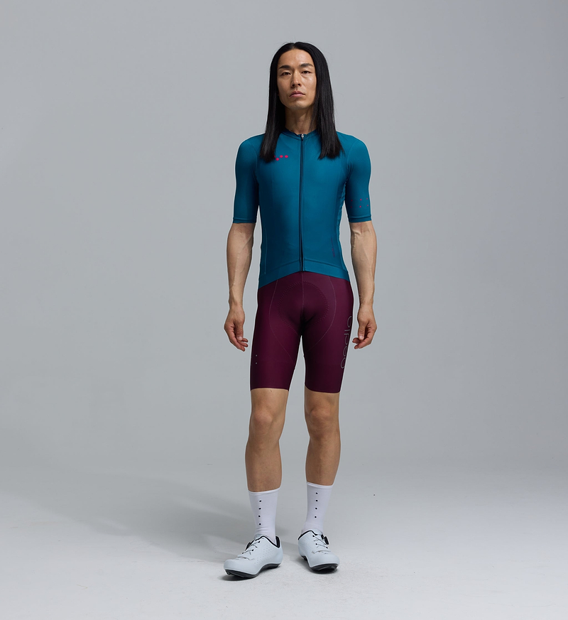 LunaLUXE men's teal Classic cycling jersey front view, breathable SPF50 moisture-wicking four-way stretch road cycling jersey with extended sleeves, low-cut collar and silicone gripper hem