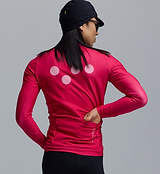 Men's fuchsia thermal long-sleeve cycling jersey with Chillblock fleeced interior, moisture-wicking breathable knit, reflective logos, UPF 50+, articulated sleeves, hem gripper and three rear pockets with zip, back close-up on rider