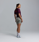 Back view of women's Specialized Essentials BOLD Classic cycling jersey in fig, LunaLUXE breathable SPF 50 fabric, moisture-wicking, four-way stretch, extended sleeves, low-cut collar and silicone hem gripper, form-fitting performance fit