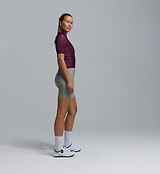 Women's Essentials BOLD LunaLUXE Classic cycling jersey in fig, side view on model, performance road top; breathable SPF50, moisture-wicking, four-way stretch, side ventilation panels, extended sleeves, low-cut collar, silicone hem gripper, slim fit