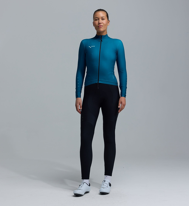 Women's thermal long-sleeve cycling jersey teal, Chillblock fabric with thermal fleeced interior, moisture-wicking breathable knit, UPF 50+, reflective details, SAB two-way zipper, hem gripper, three rear pockets