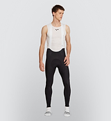 Black Essentials Men's SuperFit 2.0 Cycling Bib Tight displayed on male model, crafted from premium Italian fabric for optimal muscle support and aerodynamic performance.