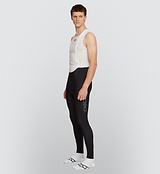 Side view of a cyclist wearing the Black Men's SuperFLEECE 2.0 Bib Tights, highlighting the fabric's moisture-wicking capabilities and thermal insulation for cold weather cycling.