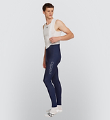 Side view of a cyclist wearing Navy Men's SuperFLEECE 2.0 Bib Tights, emphasizing the fabric's moisture-wicking capabilities and fleece-lined knit for comfortable cold weather cycling.