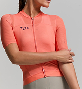 Close-up of apricot mesh fabric and jersey stitching – moisture-wicking fibres and UPF-rated lightweight material designed to enhance airflow and keep riders cool in peak summer heat.