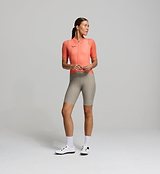 Front view of female cyclist in apricot Air Jersey – tailored performance fit with chest mesh panels for ventilation and moisture-wicking fabric for warm-weather training.