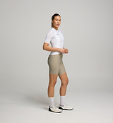 Side view of female cyclist in Core White Classic Jersey – extended sleeves, low-cut collar, and form-fitting silhouette designed for comfort and road performance.