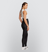 Side view of a cyclist wearing the Black Women's SuperFLEECE 2.0 Bib Tights, highlighting the aerodynamic construction and fleece-lined performance for cold-weather cycling.