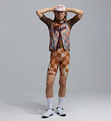 Heritage amber checkered cycling cap on model with matching checkered road cycling kit — retro-inspired café-stop style, performance road bike apparel and vintage cycling accessory