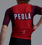 PEDLA Heritage Men's Classic cycling jersey closeup in traditional Fox Red — breathable SPF50 moisture-wicking fabric, four-way stretch, ventilation panels, extended sleeves, low-cut collar, silicone hem gripper, form-fitting.