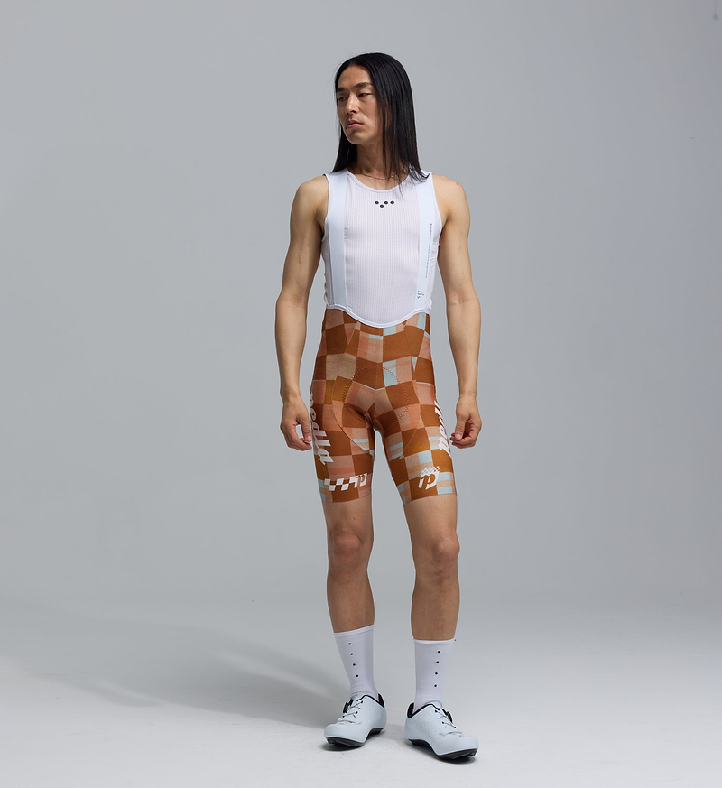 Pedla SuperFIT 2.0 men's cycling bib shorts — heritage-check high-performance Italian fabric, Elastic Interface® chamois, advanced breathable brace for muscle support & ventilation, aerodynamic race fit, seamless non-stitched cuffs with reflective logos for road cycling and long-distance comfort.