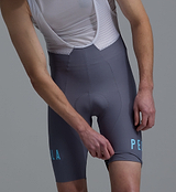 Men's Heritage Steel Training Bib Short close-up — compressive cycling bib shorts with breathable mesh bib straps, performance chamois padding, seamless cuff, reflective logos, premium European fabrics for training rides