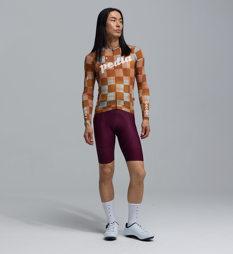Pedla Heritage men's long-sleeve training cycling jersey, Checkers Amber — UPF 30+, REPREVE recycled polyester/elastane, breathable perforated panels, moisture-wicking, four-way stretch, silicone gripper hem