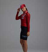 Heritage unisex fox-red Pedla cycling cap on model, retro road cap back view paired with matching red long-sleeve cycling jersey and neck tube, ideal for cafe stops and casual rides