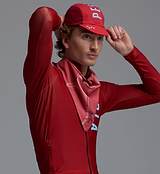 Heritage unisex red cycling cap (side view) with short visor on model — lightweight performance road and urban bike cap, stylish cafe-stop accessory
