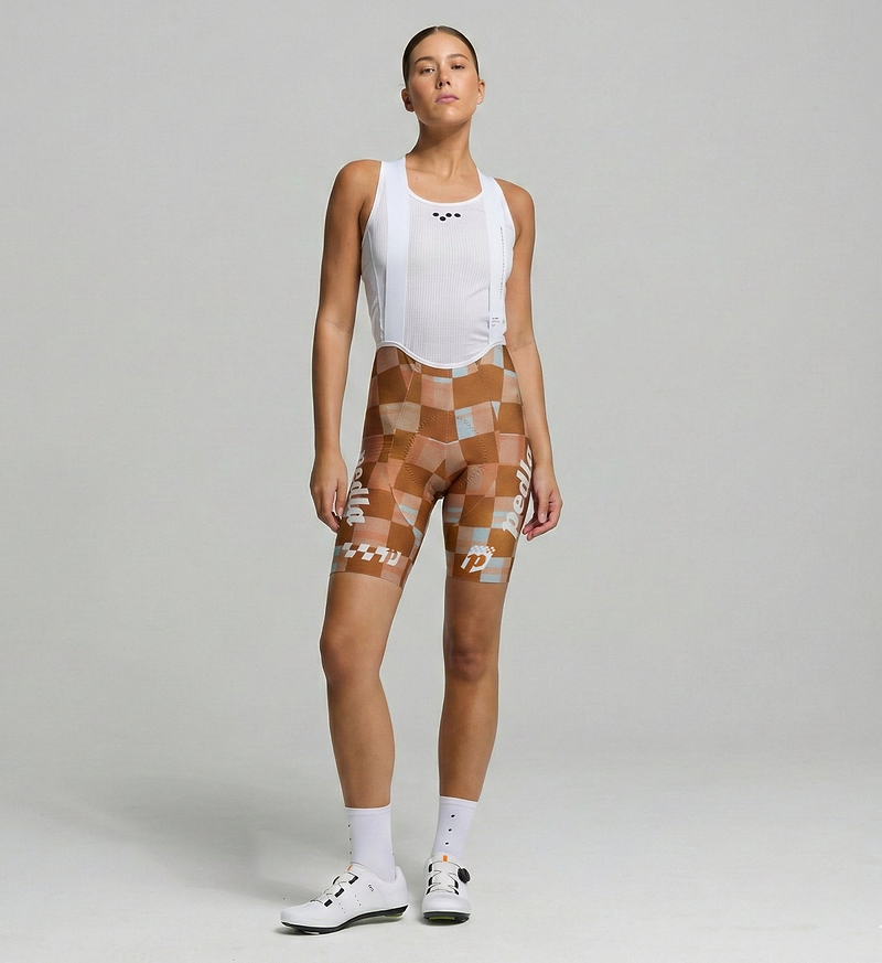 Pedla Heritage Women's SuperFIT 2.0 cycling bib shorts — amber checkers; Italian fabric, advanced brace system for superior muscle support & ventilation, Elastic Interface® chamois, seamless cuffs and reflective logos for road cycling performance