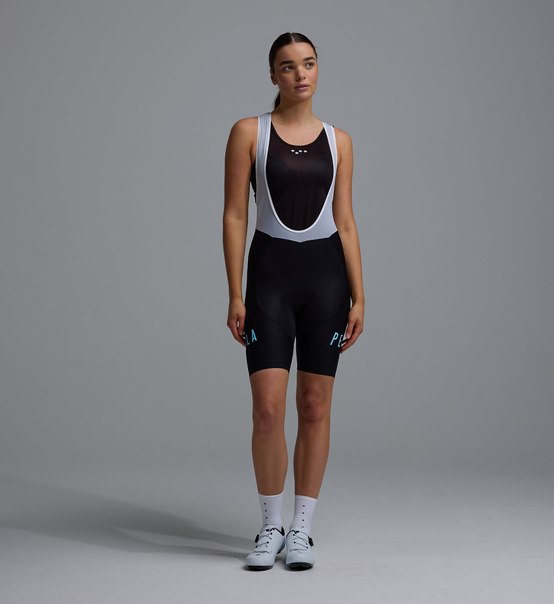 Heritage women's black training bib short, compressive European-fabric cycling bib with breathable mesh braces, seamless cuff, reflective logos and performance chamois for training and long rides