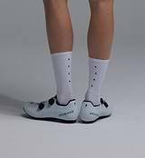 Pedla lightweight porcelain white merino wool cycling socks, mid-calf 6in cuff, moisture-wicking, temperature-regulating, odor-resistant merino blend with arch support and anatomical left/right fit, shown with white road cycling shoes