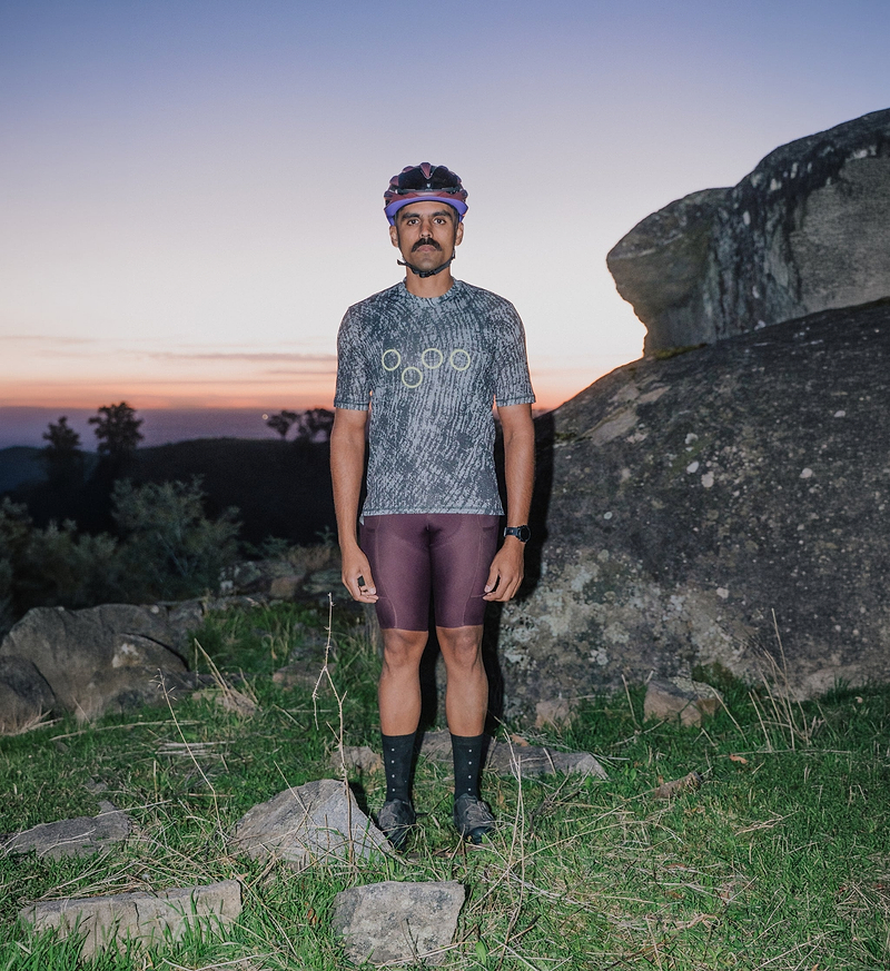 ON_OFF Grid men's cycling Tech Tee Timber Grain - front view on male cyclist; ultralight Italian knit, breathable moisture-wicking, UPF50+ sun protection, relaxed non-restrictive fit for gravel, road and endurance rides