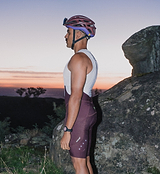 Men's Pedla SuperSYSTEM On/Off Grid fig cycling bib shorts side view on model, compressive Superfit fabric, high-density EIT chamois, integrated 1.5L hydration pocket with hose channel, side stash pockets, reflective details