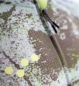 ON_OFF GRID SuperSYSTEM men's cycling jersey close-up, erosion camo print on ultralight high-stretch woven fabric, breathable moisture-wicking performance, bonded hem, yellow dot graphics, black drawcord tips, reflective accents for gravel and road