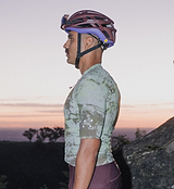 ON_OFF GRID SuperSYSTEM men's cycling jersey (Erosion) side view on rider — ultralight, high-stretch, breathable moisture-wicking gravel/road jersey with ergonomic sleeves, bonded hem, hydration channel, reflective accents