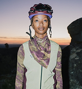 On Off Grid unisex bandana — multicolor patterned neck scarf for sun protection and styling; versatile outdoor accessory for hiking, cycling, everyday wear, modeled with bike helmet at sunset