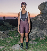 Women's Pedla SuperSYSTEM cycling bib shorts (fig) front view — compressive Superfit fabric, ultra-high-density EIT chamois, silicone leg grippers, integrated 1.5L hydration rear pocket with hose channel and side stash pockets for endurance riding