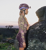 Women's ON_OFF GRID SuperSYSTEM long-sleeve cycling jersey in multi rock print — ultralight, high-stretch, breathable, moisture-wicking with hydration tube channel, bonded hem, ergonomic sleeves and reflective accents for gravel and road riding