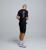 Side profile of the Men's Pro Pursuit Crit Suit – Black, showing sculpted sleeve panels with AeroPRISMA fabric, silicone leg grippers, and ergonomic design for high-speed movement.