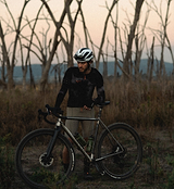 PRO UltraRACE black fingerless cycling glove (back view) on rider — low‑profile race glove with breathable, moisture‑wicking upper, grippy padded palm and strategic low‑profile padding for pressure relief and vibration damping; ergonomic fit for road and gravel racing, lightweight summer performance for maximum bar feel and minimal distraction