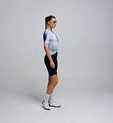 Side profile of the AirFoils White short sleeve jersey worn by a cyclist, showing the breathable mesh underarm paneling and clean heat-sealed sleeve finish for aerodynamic performance.