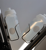 White Pedla bidon securely mounted in bike bottle cage; compact, accessible, and perfect for hydration on the move.
