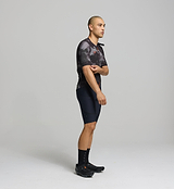 Side profile of dark purple men’s cycling jersey – ergonomic sleeve design and hydration tube channel for long-distance cycling support