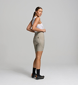 Side profile of pumice SuperSYSTEM women’s bib shorts – stash pocket detail and breathable fabric designed for endurance performance