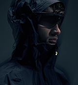PEDLA x N-0 waterproof 3-layer black shell jacket close-up, laminated stretch nylon, fully taped seams, adjustable hood, YKK waterproof zipper — technical cycling rain jacket, unisex urban commuter
