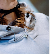 PEDLA x N-0 grey cropped heavyweight cotton hoodie close-up, garment-washed 100% cotton fleece, two-piece hood with drawcord and toggles, front kangaroo pocket and ribbed cuffs — unisex technical streetwear for on and off the bike