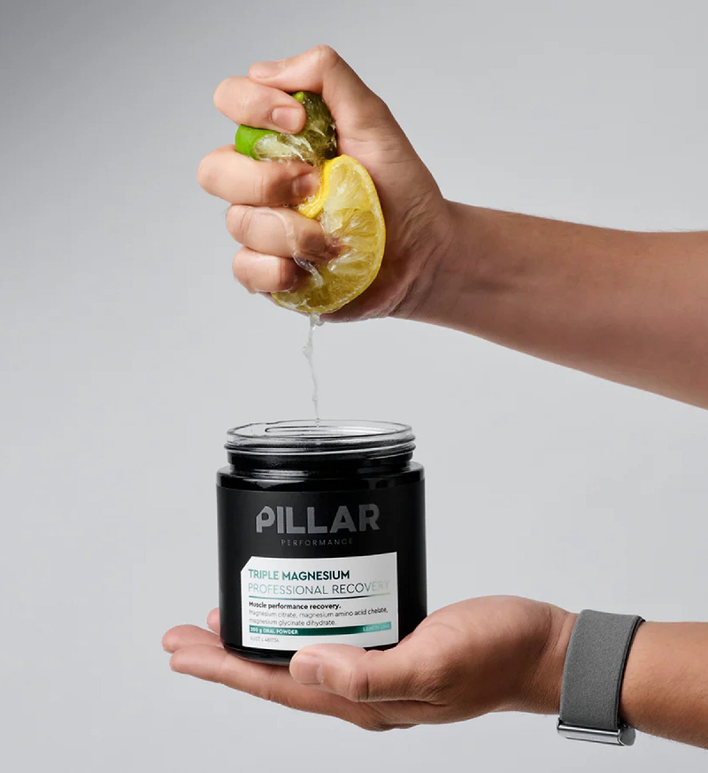 PILLAR Performance TRIPLE MAGNESIUM Powder jar (Unflavoured) with hand squeezing lemon — triple magnesium blend (citrate, glycinate, bisglycinate) for muscle recovery, sleep & cramp relief; vegan, gluten‑free, sport‑safe