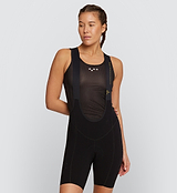 Back view of Pro Women's SuperFit Air Bib Shorts in Black on model, featuring a breathable perforated back panel, sleek brace system, and reflective accents for enhanced airflow, comfort, and visibility during intense road cycling.