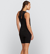 Side view of model wearing Pro Women's SuperFit Air Bib Shorts in Black, showcasing the sleek brace system, compressive fit, and reflective accents that ensure support, visibility, and performance during high-intensity cycling sessions.