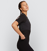 Side view of Pro Women's Velocity Cycling Jersey in Black on model, highlighting the aerodynamic sleeve channels, next-to-skin fit, and lightweight fabric that reduce drag and optimise speed during long-distance road cycling.