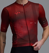 Race Division men's training cycling jersey close-up in deep red grid, REPREVE recycled polyester, UPF 30+, breathable perforated panels, moisture-wicking four-way stretch, silicone gripper hem, extended sleeves